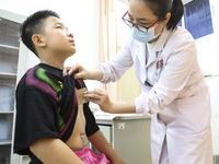 

A medical worker is applying traditional Chinese medicine Sanfu stickers to a citizen in Huai'an City, Jiangsu Province, China, on July 11...