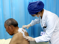 

A doctor at a traditional Chinese medicine clinic is applying "Sanfu stickers" to an elderly person in Zaozhuang, Shandong Province, China...