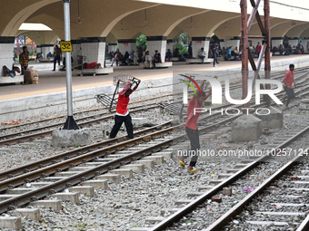 Bangladeshi railway porter carries a trolley at Kamalapur Railway Station in Dhaka, Bangladesh, on July 11, 2023 (