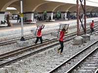 Bangladeshi railway porter carries a trolley at Kamalapur Railway Station in Dhaka, Bangladesh, on July 11, 2023 (