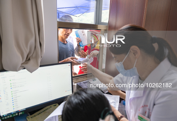 YICHANG, CHINA - JULY 13, 2023 - People receive free medicines at the pharmacy of Central Health center in Yanglinqiao town of Zigui County,...