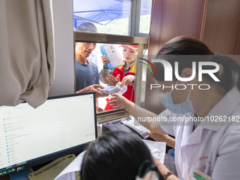 YICHANG, CHINA - JULY 13, 2023 - People receive free medicines at the pharmacy of Central Health center in Yanglinqiao town of Zigui County,...