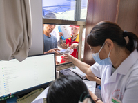 YICHANG, CHINA - JULY 13, 2023 - People receive free medicines at the pharmacy of Central Health center in Yanglinqiao town of Zigui County,...