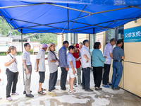 YICHANG, CHINA - JULY 13, 2023 - People receive free medicines at the pharmacy of Central Health center in Yanglinqiao town of Zigui County,...