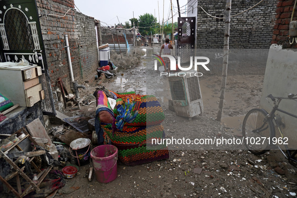 Damaged belongings are seen outside a home as flood water recedes in a low-lying area, after a rise in the waters of river Yamuna due to hea...