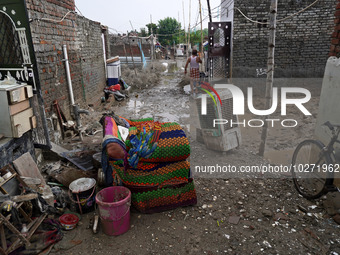 Damaged belongings are seen outside a home as flood water recedes in a low-lying area, after a rise in the waters of river Yamuna due to hea...