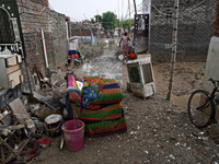 Damaged belongings are seen outside a home as flood water recedes in a low-lying area, after a rise in the waters of river Yamuna due to hea...