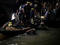 A water bus with more than half a hundred passengers sank after being hit by a sand-laden bulkhead in the Buriganga river at Sadarghat in Dh...