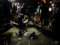 A water bus with more than half a hundred passengers sank after being hit by a sand-laden bulkhead in the Buriganga river at Sadarghat in Dh...