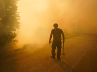 Fireman  during a wildfire in southern urban of Attica, Greece, on 17, July 2023. Fire fighting forces battling a blaze that broke out on Mo...