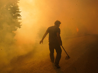 Residents fighting the fire  during a wildfire in southern urban of Attica, Greece, on 17, July 2023. Fire fighting forces battling a blaze...