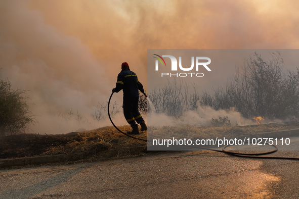 Fireman  during a wildfire in southern urban of Attica, Greece, on 17, July 2023. Fire fighting forces battling a blaze that broke out on Mo...