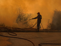 Fireman during a wildfire in southern urban of Attica, Greece, on 17, July 2023. Fire fighting forces battling a blaze that broke out on Mon...