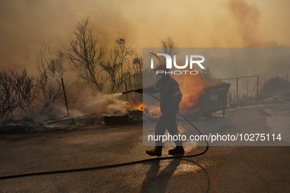 Fireman during a wildfire in southern urban of Attica, Greece, on 17, July 2023. Fire fighting forces battling a blaze that broke out on Mon...