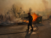 Fireman during a wildfire in southern urban of Attica, Greece, on 17, July 2023. Fire fighting forces battling a blaze that broke out on Mon...