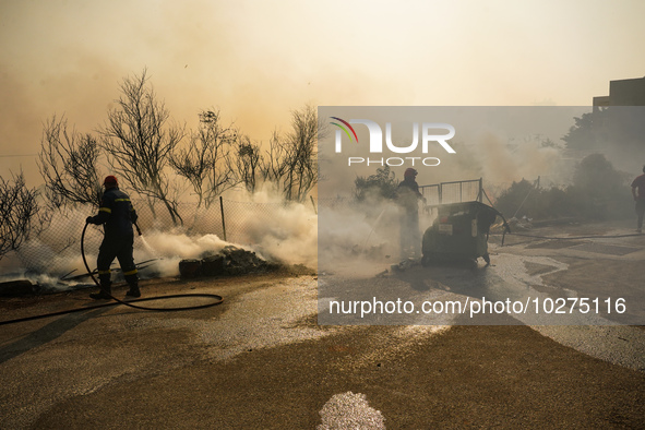 Fireman is fighting the fire  during a wildfire in southern urban of Attica, Greece, on 17, July 2023. Fire fighting forces battling a blaze...