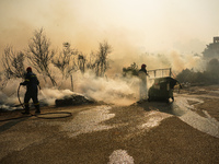 Fireman is fighting the fire  during a wildfire in southern urban of Attica, Greece, on 17, July 2023. Fire fighting forces battling a blaze...