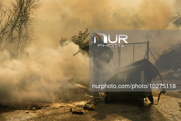 Fireman is fighting the fire  during a wildfire in southern urban of Attica, Greece, on 17, July 2023. Fire fighting forces battling a blaze...