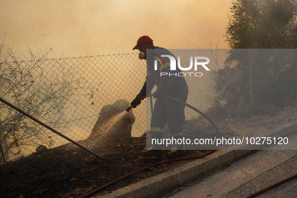 Fireman is fighting the fire  during a wildfire in southern urban of Attica, Greece, on 17, July 2023. Fire fighting forces battling a blaze...