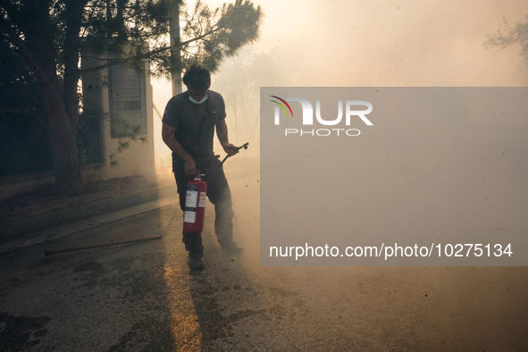 Fireman is fighting the fire  during a wildfire in southern urban of Attica, Greece, on 17, July 2023. Fire fighting forces battling a blaze...