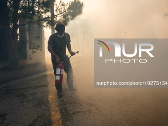 Fireman is fighting the fire  during a wildfire in southern urban of Attica, Greece, on 17, July 2023. Fire fighting forces battling a blaze...