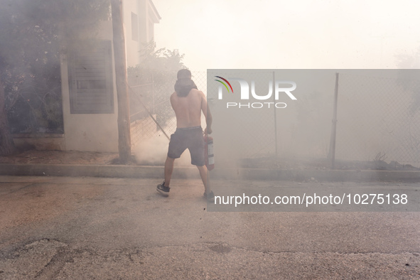 Fireman is fighting the fire  during a wildfire in southern urban of Attica, Greece, on 17, July 2023. Fire fighting forces battling a blaze...