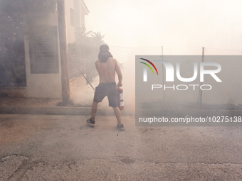 Fireman is fighting the fire  during a wildfire in southern urban of Attica, Greece, on 17, July 2023. Fire fighting forces battling a blaze...