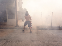 Fireman is fighting the fire  during a wildfire in southern urban of Attica, Greece, on 17, July 2023. Fire fighting forces battling a blaze...