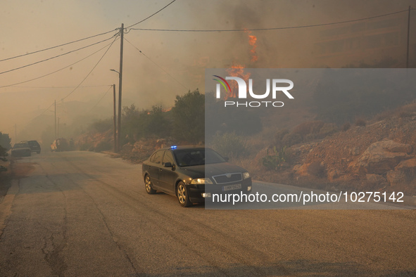 Fire during a wildfire in southern urban of Attica, Greece, on 17, July 2023. Fire fighting forces battling a blaze that broke out on Monday...