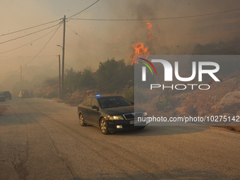 Fire during a wildfire in southern urban of Attica, Greece, on 17, July 2023. Fire fighting forces battling a blaze that broke out on Monday...