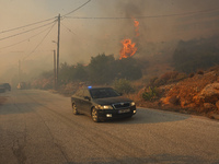 Fire during a wildfire in southern urban of Attica, Greece, on 17, July 2023. Fire fighting forces battling a blaze that broke out on Monday...