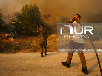 Fire during a wildfire in southern urban of Attica, Greece, on 17, July 2023. Fire fighting forces battling a blaze that broke out on Monday...