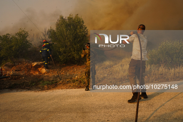 Fire during a wildfire in southern urban of Attica, Greece, on 17, July 2023. Fire fighting forces battling a blaze that broke out on Monday...