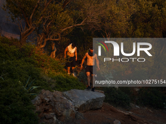 Residents fighting the fire  during a wildfire in southern urban of Attica, Greece, on 17, July 2023. Fire fighting forces battling a blaze...