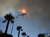 A firefighting helicopter operates in Saronida near Athens, Greece on July 17, 2023. (