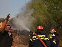 Firefighters operate as a wildfire rages in Saronida near Athens, Greece on July 17, 2023. (