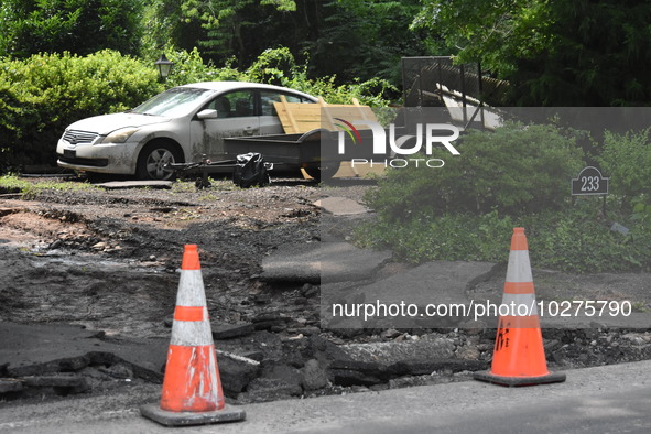 Severe flooding damage and buckling roads in Lower Makefield Township, Pennsylvania, United States on July 17, 2023. Several fatalities and...