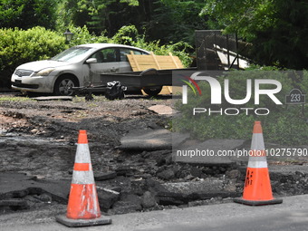 Severe flooding damage and buckling roads in Lower Makefield Township, Pennsylvania, United States on July 17, 2023. Several fatalities and...