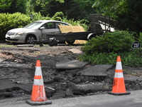 Severe flooding damage and buckling roads in Lower Makefield Township, Pennsylvania, United States on July 17, 2023. Several fatalities and...