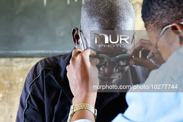 An ophthalmologist examine a man's eye during a free medical outreach by LFC Jahi at Mpape, Abuja, on july 18, 2023.  