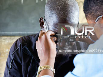 An ophthalmologist examine a man's eye during a free medical outreach by LFC Jahi at Mpape, Abuja, on july 18, 2023.  (