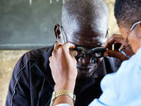 An ophthalmologist examine a man's eye during a free medical outreach by LFC Jahi at Mpape, Abuja, on july 18, 2023.  (