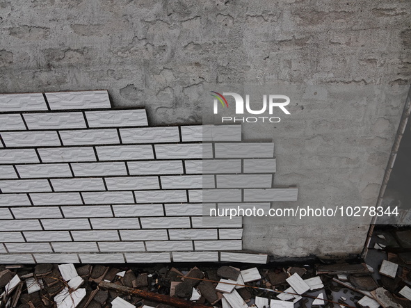 

Tiles are falling off the exterior wall of a high-rise residential building in Yichang, Hubei province, China, on July 19, 2023. With the...