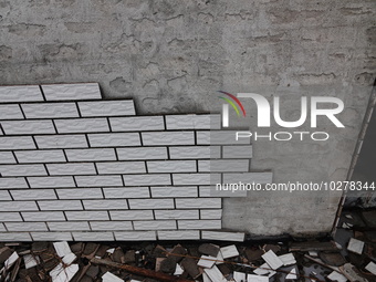 

Tiles are falling off the exterior wall of a high-rise residential building in Yichang, Hubei province, China, on July 19, 2023. With the...