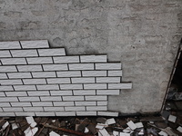 

Tiles are falling off the exterior wall of a high-rise residential building in Yichang, Hubei province, China, on July 19, 2023. With the...