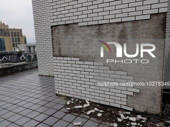 

Tiles are falling off the exterior wall of a high-rise residential building in Yichang, Hubei province, China, on July 19, 2023. With the...