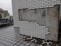 

Tiles are falling off the exterior wall of a high-rise residential building in Yichang, Hubei province, China, on July 19, 2023. With the...