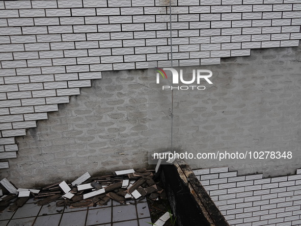 

Tiles are falling off the exterior wall of a high-rise residential building in Yichang, Hubei province, China, on July 19, 2023. With the...