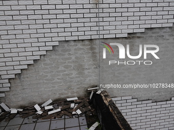 

Tiles are falling off the exterior wall of a high-rise residential building in Yichang, Hubei province, China, on July 19, 2023. With the...