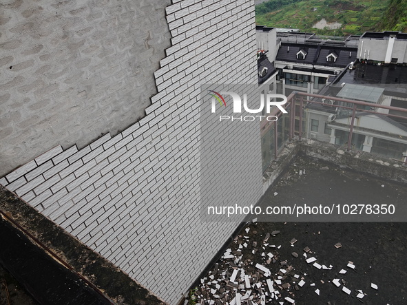 

Tiles are falling off the exterior wall of a high-rise residential building in Yichang, Hubei province, China, on July 19, 2023. With the...